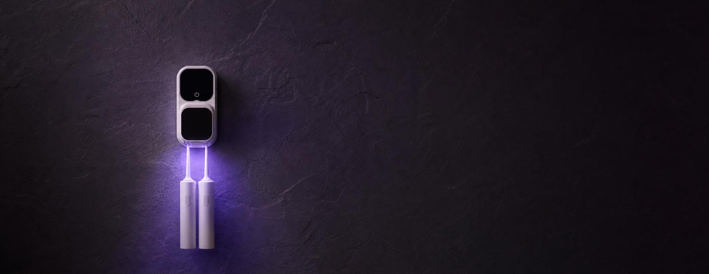 Lumivé glowing violet on a dark wall